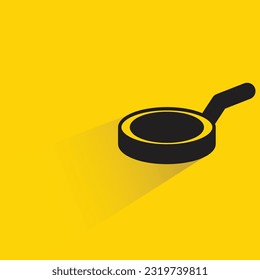 pan with shadow on yellow background