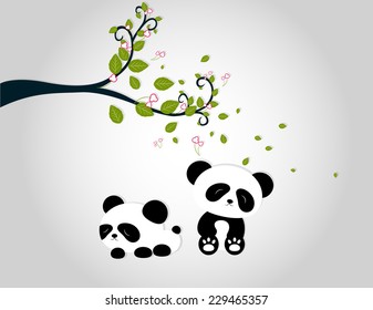 panda playing under tree branches