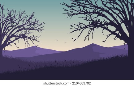 Panorama of the mountains in the beautiful morning with the silhouette of dry trees around it