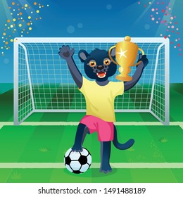 A panther in uniform standing on the ball and cheering with goblet on the soccer field
