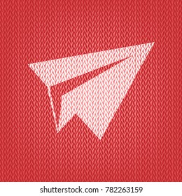 Paper airplane sign. Vector. Knitted white icon on a red knitted background.