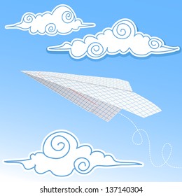 Paper airplane in the sky with paper decorative clouds