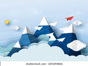 Paper airplanes flying above mountains and blue sky.Paper art style of business teamwork creative concept idea.
