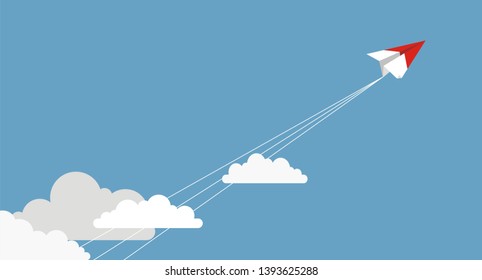 Paper airplanes flying from clouds on blue sky