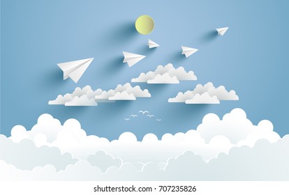 paper airplanes flying over clouds. design with art paper and craft.