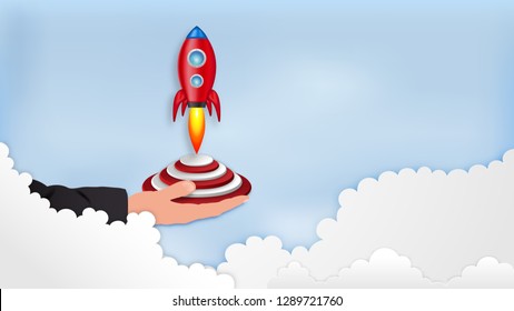 Paper art , cut and craft style of Rocket launch on hand as business start up and sucess concept. vector illustration.
