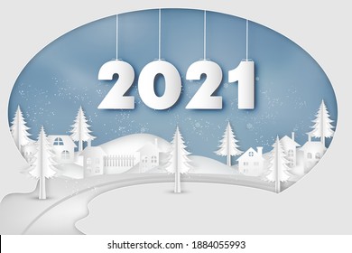 Paper art and cut of year 2021 in the winter season with trees , forest and snow on the blue sky as Happy New Year 2021 and digital craft style concept.
