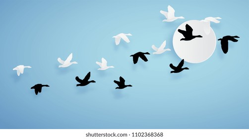 paper art of duck or teal birds flying to the sky on blue background and sun. paper cut concept.