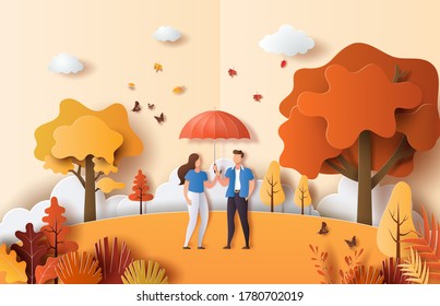 Paper art style of autumn landscape with cute couple in love holding umbrella in a park.