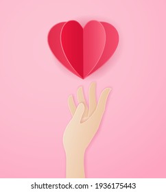 Paper art style of hand carrying red paper heart on pink background, Vector illustration