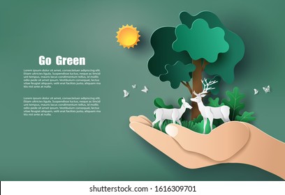 Paper art style of hand holding tree and plants with deers, save the planet and energy concept.