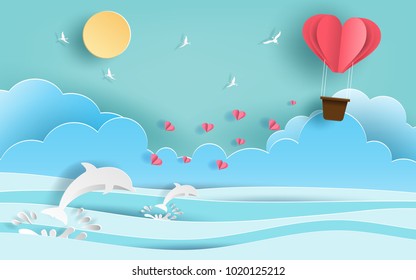 Paper art style of origami heart shaped hot air balloon flying in the air over beautiful beach with many hearts floating, flat-style vector illustration.