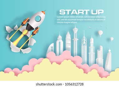 Paper art style of rocket breaking through paper over modern city, start up business concept, flat-style vector illustration.