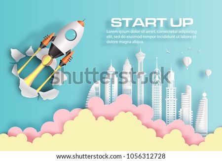 Paper art style of rocket breaking through paper over modern city, start up business concept, flat-style vector illustration.