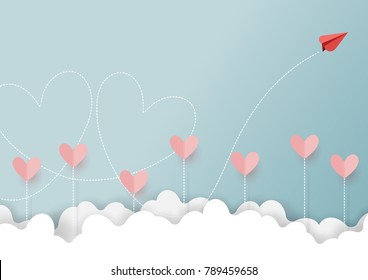 Paper art style of valentine's day greeting card and love concept.Red paper airplane flying look like couple of heart shape on clouds and blue sky.Vector illustration.