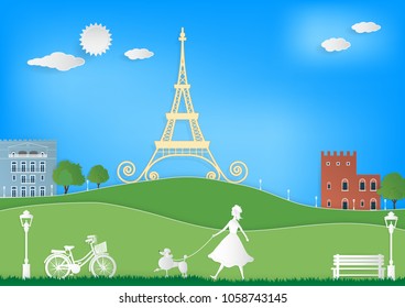 Paper art vector illustration of Eiffel tower, vintage buildings, white chair, white lantern, green mountains, green trees, green grass and woman walking with her poodle dog on blue sky background.