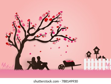 Paper art vector illustration of love couple and wheelbarrow under tree of love in autumn season and white fence, bird houses on romance pink grass and background for Valentine festival.