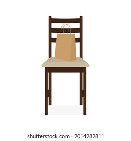 Paper bag stands on a chair on a white background