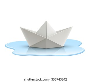 Paper boat in puddle