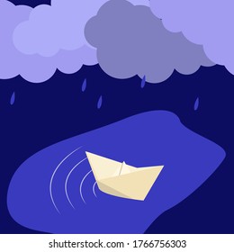 paper boat in a puddle in the rain
