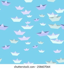 Paper boats on a blue background. Seamless.