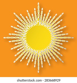 Paper bright shining sun on the orange sky.