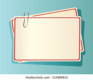 paper cards with red edging, fastened together with a staple in blue background