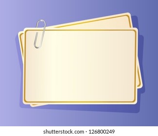 paper cards with yellow edging, fastened together with a staple in blue background