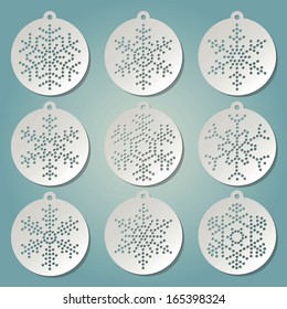 Paper christmas balls with punched snow flakes. Christmas tree decorations. 