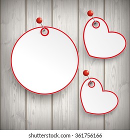 Paper circle with hearts and pins on the wooden background. Eps 10 vector file.