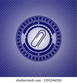 paper clip icon inside badge with denim background