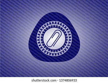 paper clip icon inside badge with denim texture