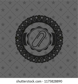 paper clip icon inside black emblem