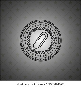 paper clip icon inside black emblem