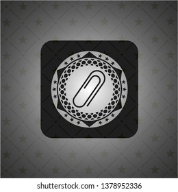 paper clip icon inside black emblem