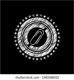 paper clip icon inside chalkboard emblem written on a blackboard