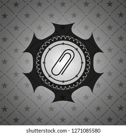 paper clip icon inside dark badge or emblem