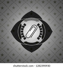 paper clip icon inside dark badge or emblem