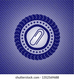 paper clip icon inside emblem with denim texture