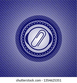 paper clip icon inside emblem with denim texture