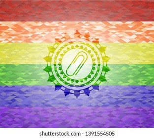 paper clip icon inside emblem on mosaic background with the colors of the LGBT flag