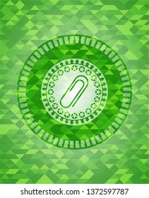 paper clip icon inside green emblem. Mosaic background