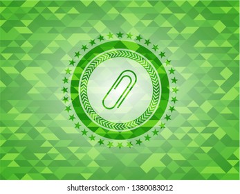 paper clip icon inside green emblem with mosaic ecological style background