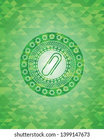 paper clip icon inside green emblem. Mosaic background