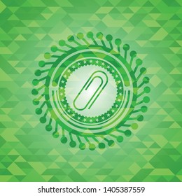 paper clip icon inside green emblem. Mosaic background