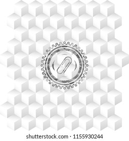 paper clip icon inside grey badge with geometric cube white background