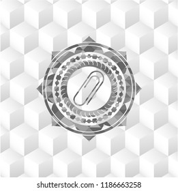 paper clip icon inside grey badge with geometric cube white background