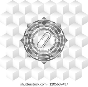 paper clip icon inside grey icon or emblem with geometric cube white background