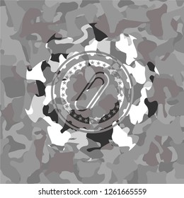 paper clip icon inside grey camo emblem