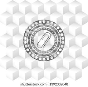 paper clip icon inside grey emblem with cube white background